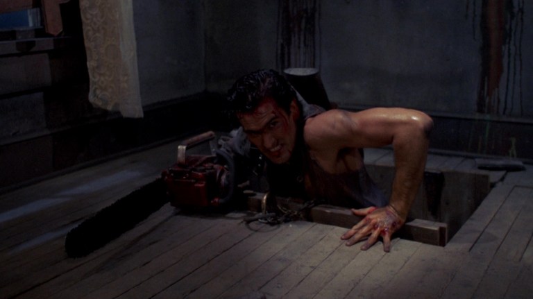Ash emerges from a basement in Evil Dead II (1987).