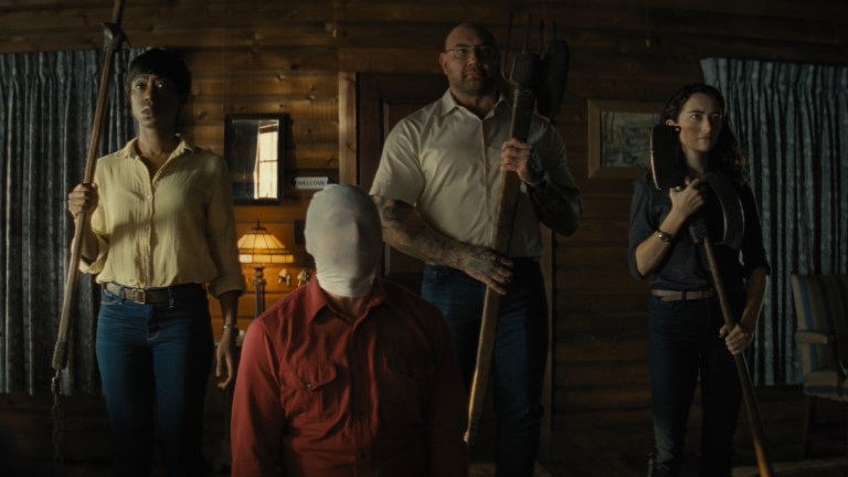 Nikki Amuka-Bird, Rupert Grint (face covered), Dave Bautista, and Abby Quinn in Knock at the Cabin.