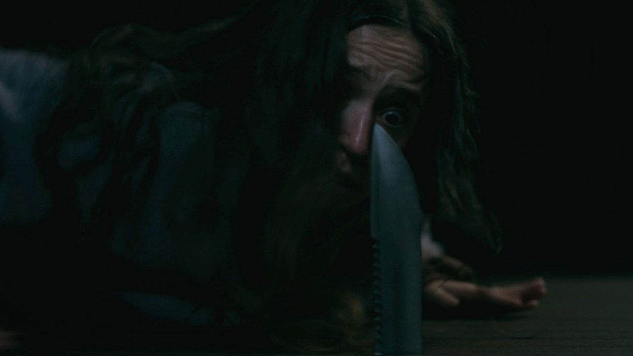A knife stabs up through a raft in Sick (2023).