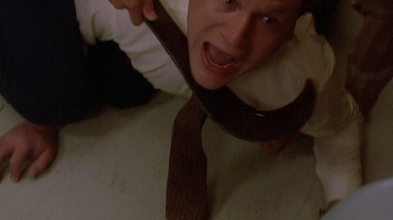 A man is attacked with a sickle in Children of the Corn (1984).