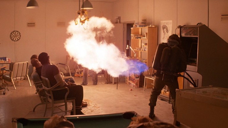 A flamethrower throwing flames in a small room in The Thing (1982).