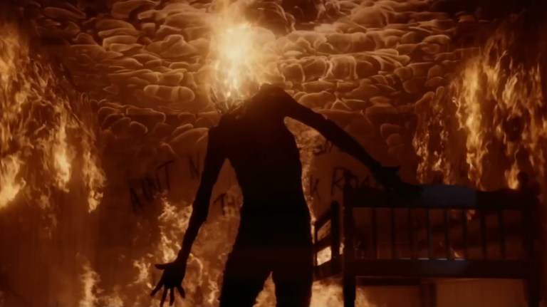 Sawtooth Jack stands in fire in Dark Harvest (2023).