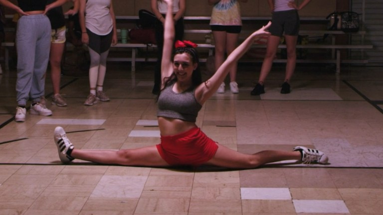 A cheerleader does the splits in Teenage Vampire (2020).