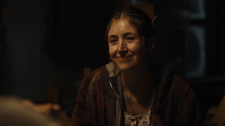 Kate Lyn Sheil smiles as Aline in The Seeding (2023).