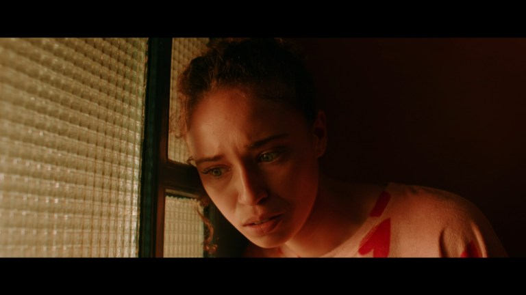 Jadyn listens at her front door in My Bloody Galentine (2024).