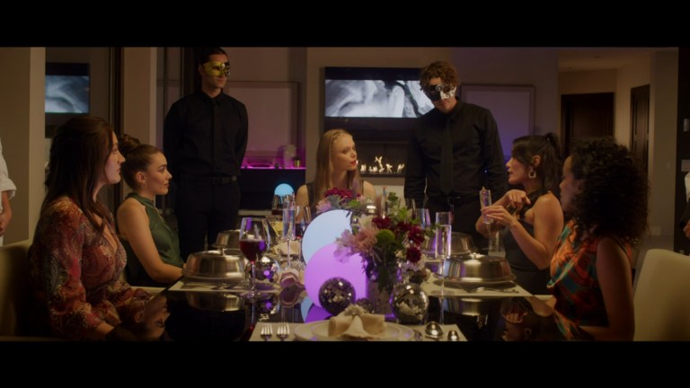 The cast of Prey for the Bride (2024) sits together for a dinner party.
