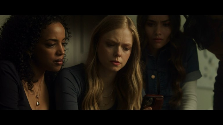Dorit, Jordan, and April watch a video on a phone in Prey for the Bride (2024).