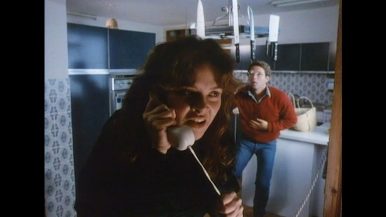 Moira Sinise answers the phone in The Fantasist (1986).