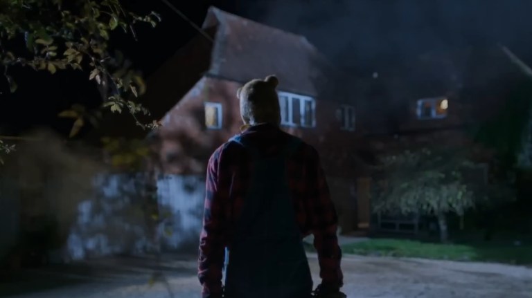 Pooh, seen from behind, standing in front of a large house in Winnie-the-Pooh: Blood and Honey 2.