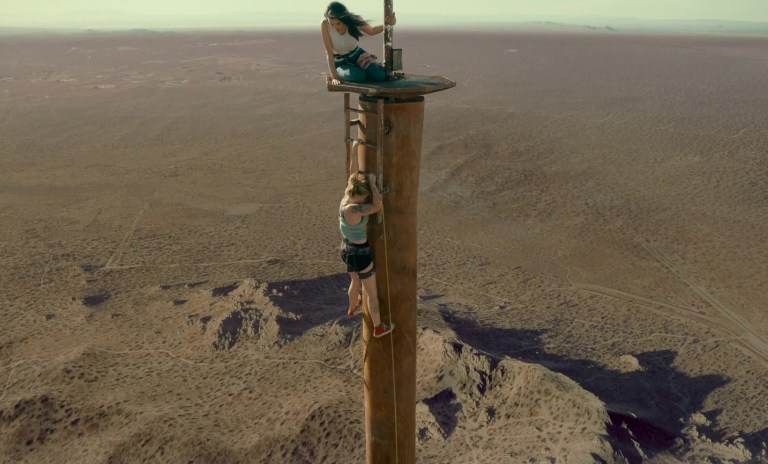 Two young women trapped on the top of a broadcast tower look for a way down in Fall (2022).
