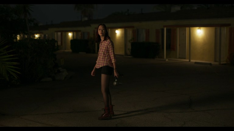 Alice stands alone in the motel in Night Shift (2023).
