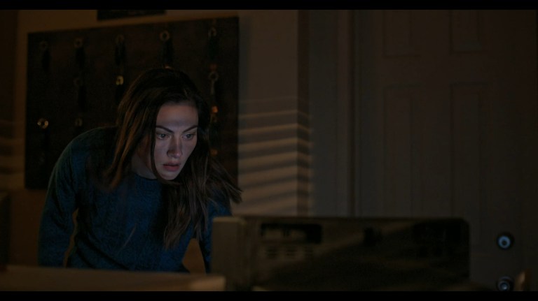 Gwen checks a security monitor in Night Shift (2023).