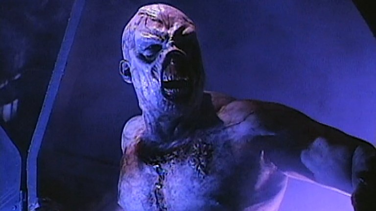 A demonic zombie steps through a portal in The Dead Hate the Living (2000).