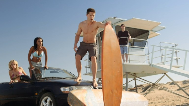 Partiers trapped in a car and a lifeguard station attempt to cross deadly sand in The Sand (2015).