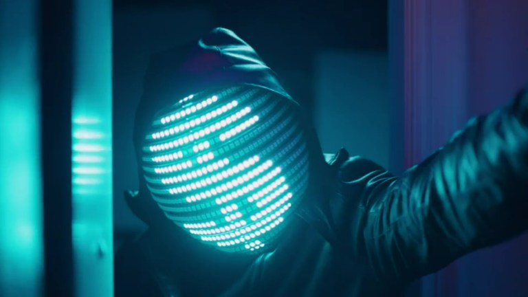 The killer's light-up mask shows a dollar sign in Amp House Massacre (2024).