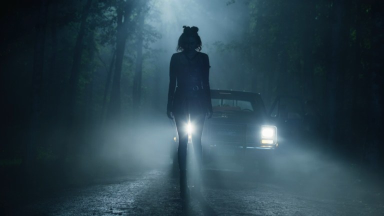 Destini stands silhouetted in front of a truck's headlights in Festival of the Living Dead (2024).
