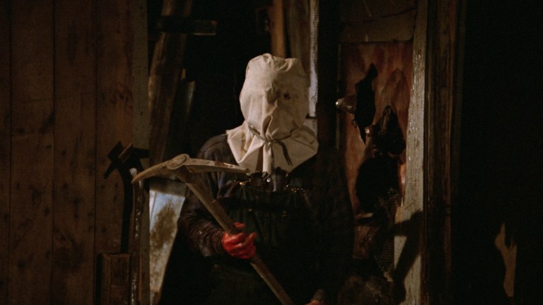 Jason wears a bag and carries a pickaxe in Friday the 13th Part 2 (1981).