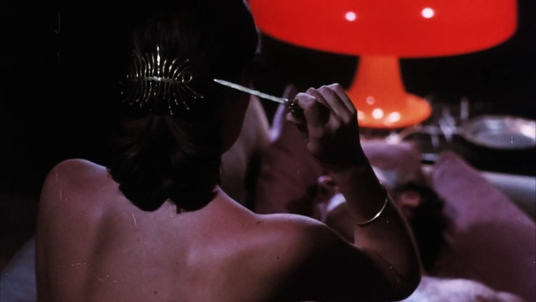 A woman pulls a hidden blade from her hair in Mary, Mary, Bloody Mary (1975).