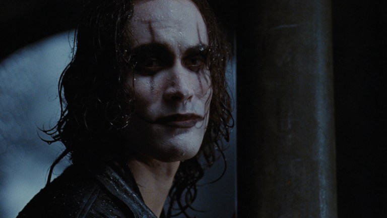 Eric Draven with a sad smile on his face in The Crow (1994).