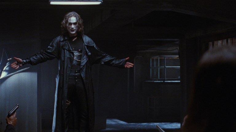 Eric Draven holds his hands out to his side during a climactic scene in The Crow (1994).