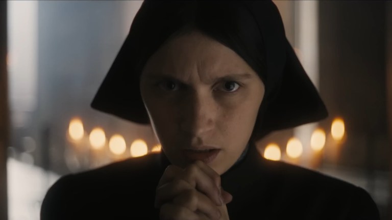 Nell Tiger Free prays as Margaret in The First Omen (2024).