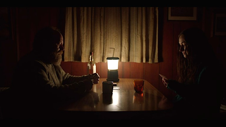 Patrick and The Visitor plays cards in You'll Never Find Me (2023).