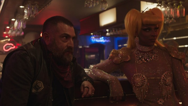 Travis and Olive Wood sit at the bar in Slay (2024).