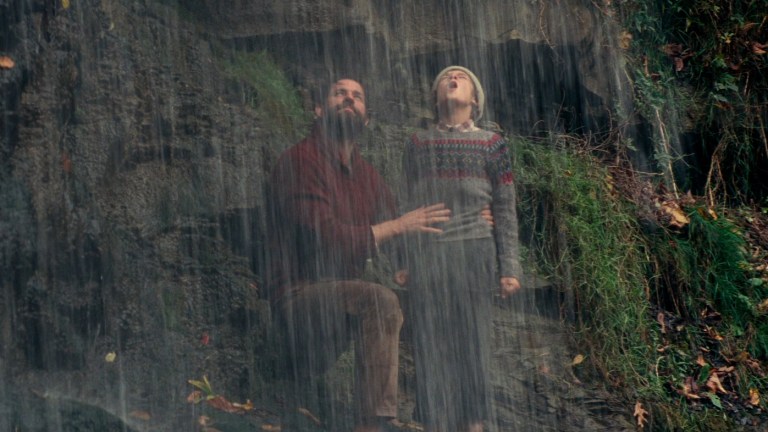 Lee and Marcus share a moment behind a waterfall in A Quiet Place (2018).
