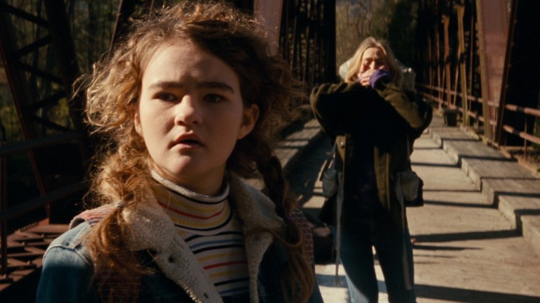 Regan and Evelyn watch as Lee runs for Beau in A Quiet Place (2018).