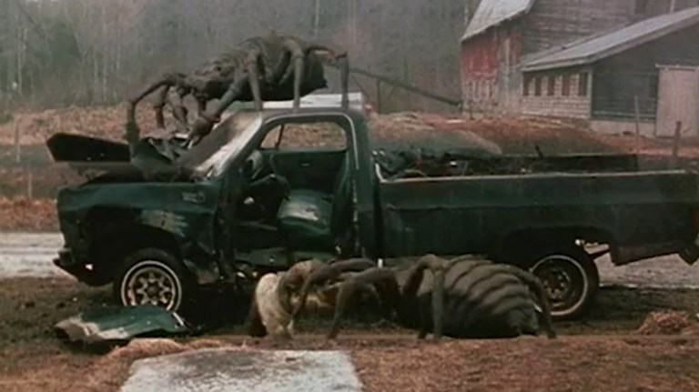 Two giant spiders tear apart a truck in Arachnia (2003).