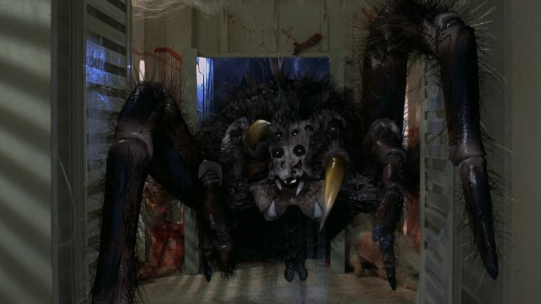 A giant spider in a bloody hallway in SPiders II: Breeding Ground (2001).