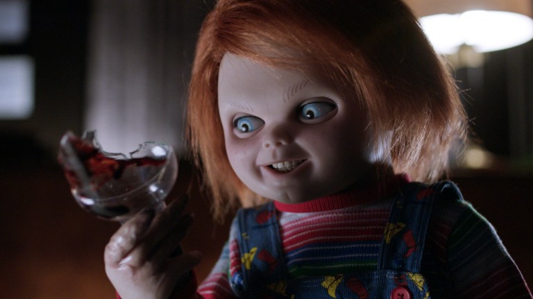 Chucky looks at a broken bottle in Cult of Chucky (2017).