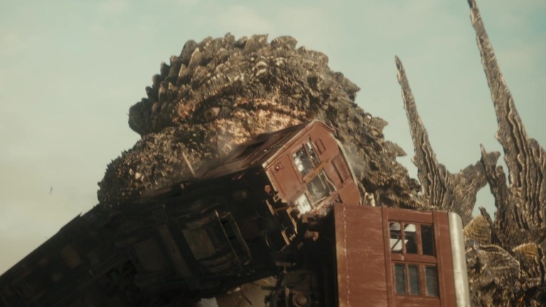 Godzilla chomps on a train in Godzilla Minus One (2023).