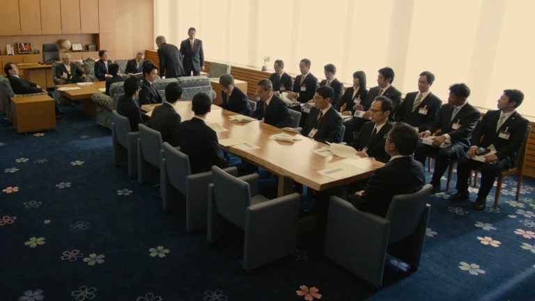 One of many meetings seen in Shin Godzilla (2016).