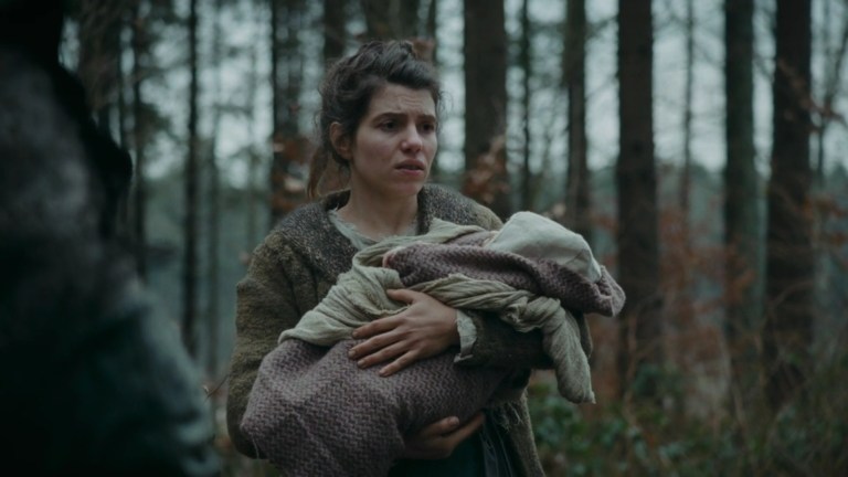 Agnes holds a baby in The Devil's Bath (2024).