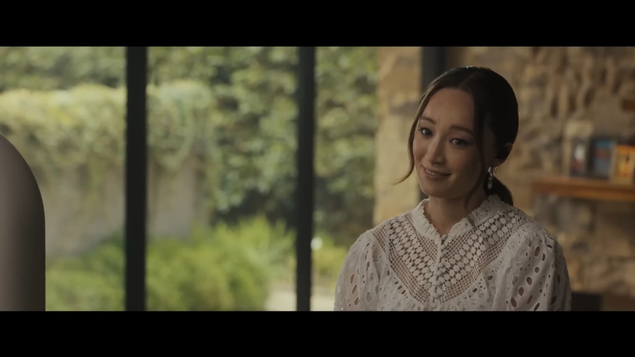 Melody smiles in a caring and understanding way in Afraid (2024).