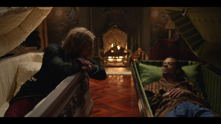 Lestat leans out of his casket and looks at Louis in Interview with the Vampire (2022).