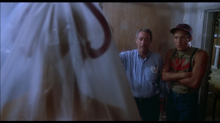 Frank and Freddy look at a frozen corpse in The Return of the Living Dead (1985).