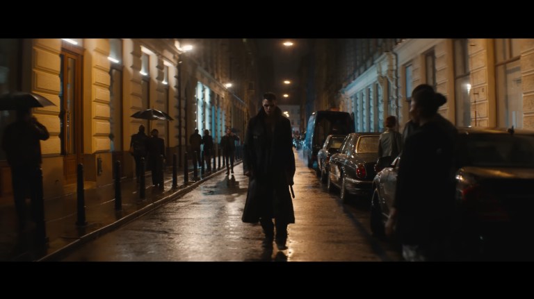 Eric gets some strange looks as he walks down a street in makeup and carrying a sword in The Crow (2024).