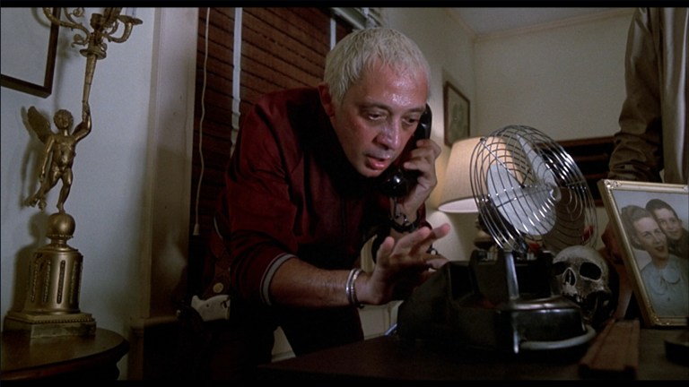 Don Calfa uses a phone in The Return of the Living Dead (1985).