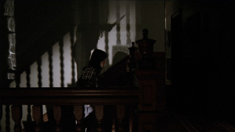 Samantha walks up a stairway in The House of the Devil (2009).