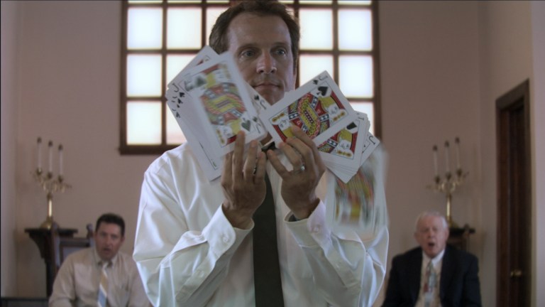 Cotton Marcus does a card trick in The Last Exorcism (2010).