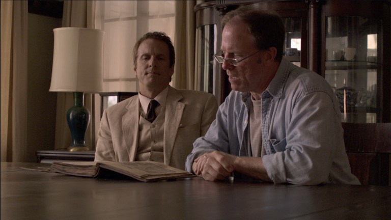 Cotton Marcus watches as Louis tries to read Latin in The Last Exorcism (2010).
