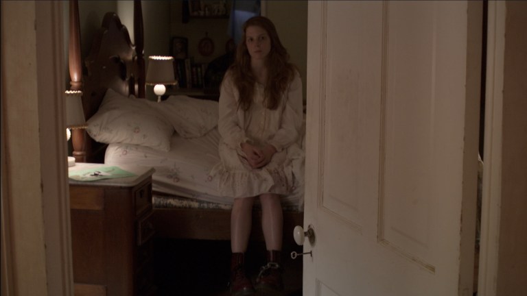 Nell looks towards the camera in The Last Exorcism (2010).