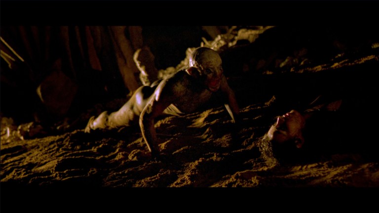 A crawler approaches Holly in The Descent (2005).