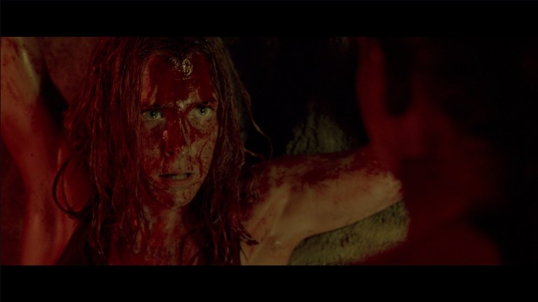 Sarah questions Juno in The Descent (2005).