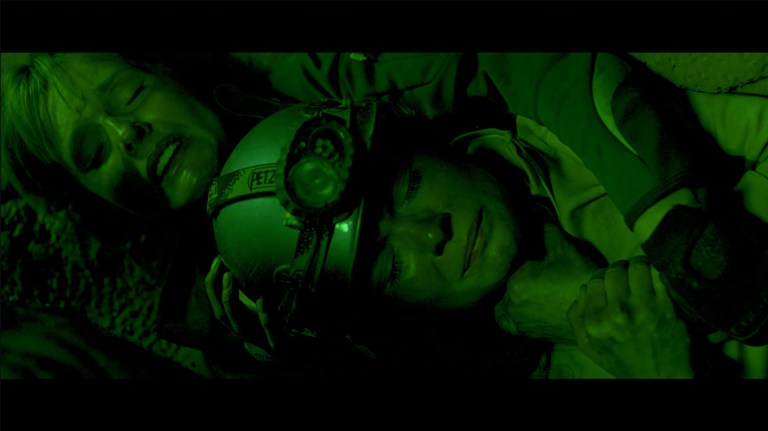 Rebecca and Sam hide from crawlers in The Descent (2005).