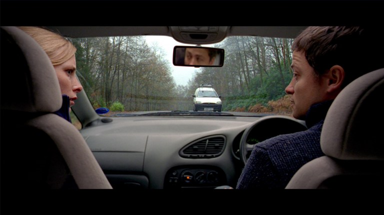 Sarah and Paul look at each other right before their car crash in The Descent (2005).