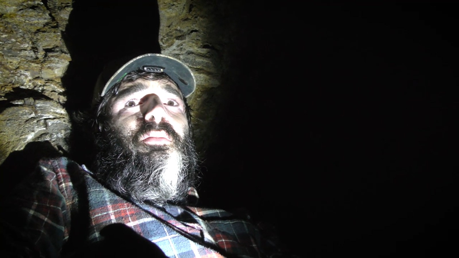 Pete holding a flashlight in Wilderness Tapes: Volume One