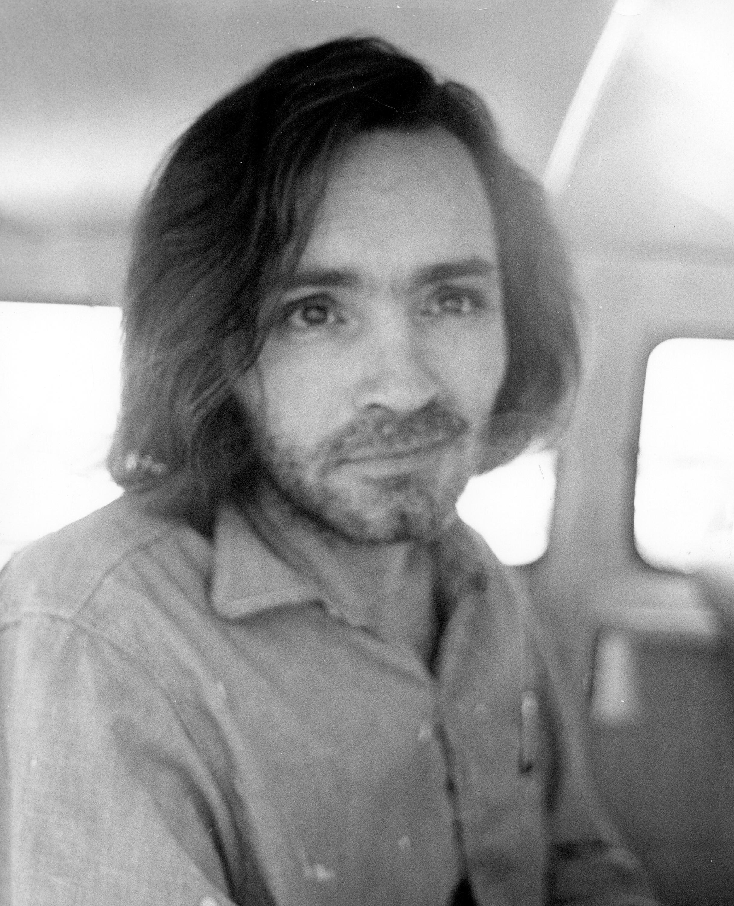 Charles Manson in a police van on the way to a courthouse hearing in Los Angeles, 1970